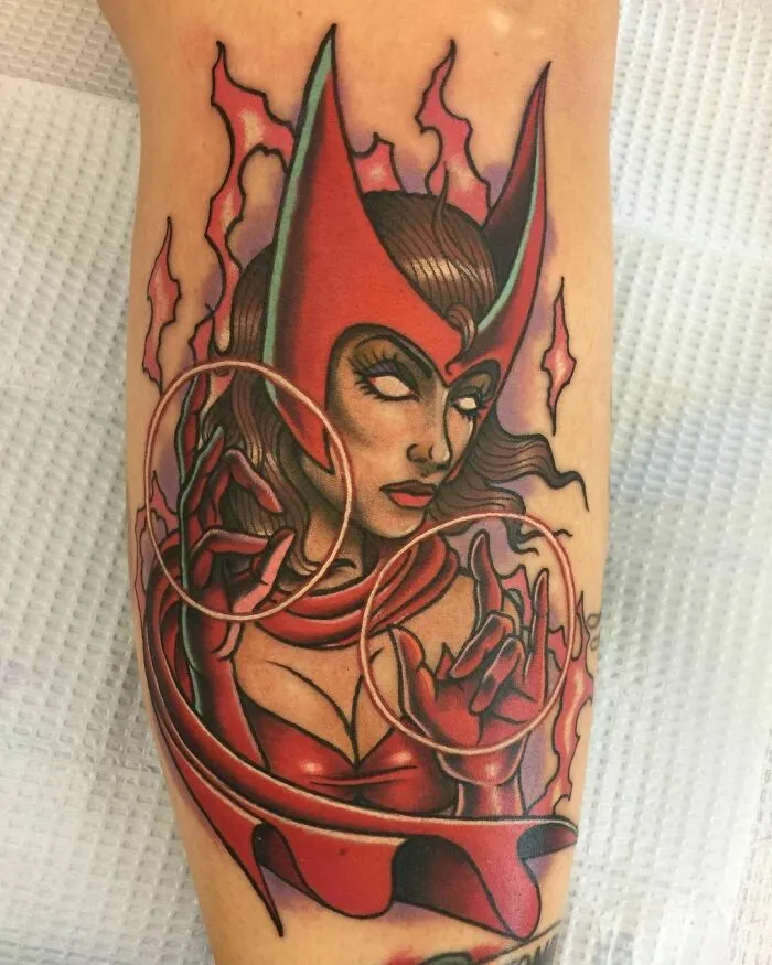 Marvel tattoo of a powerful female character in a red outfit with magical effects, showcasing vibrant colors and intricate design.