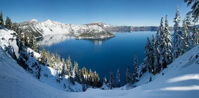 the lake between a snowy mountains