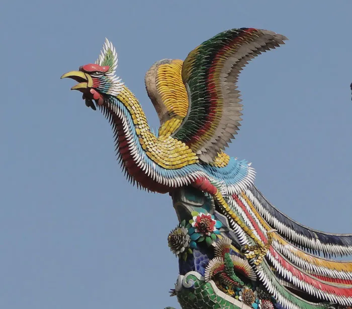 Statue of Fenghuang on a houses roof 