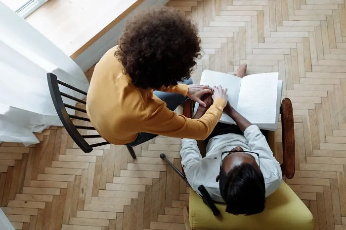 Woman Mentoring Man And Holding His Hands 