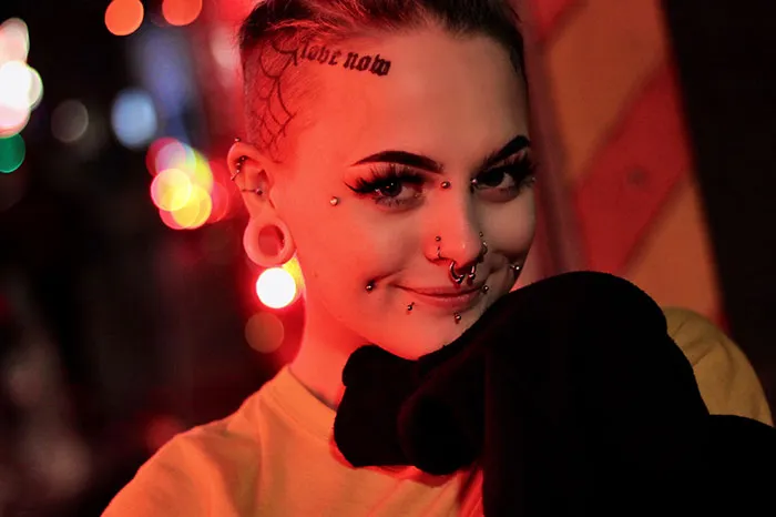 Woman with many earrings looking