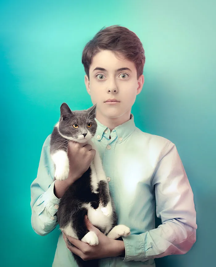 Woman holding cat and looking
