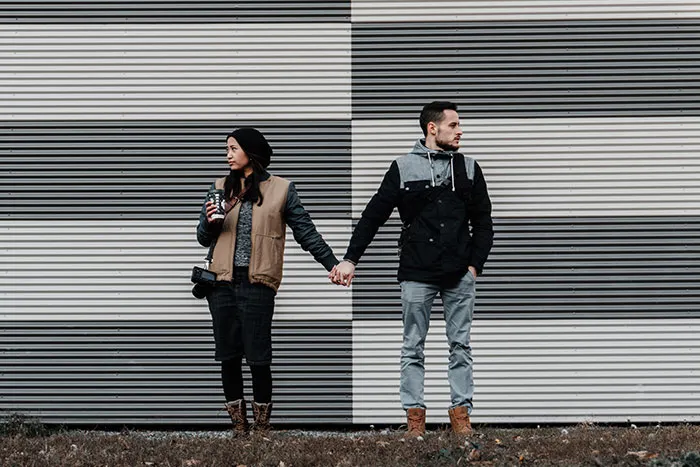 Woman and man holding hands