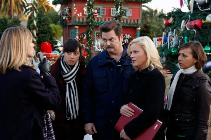 Lesslie and Ron talking  to a woman 