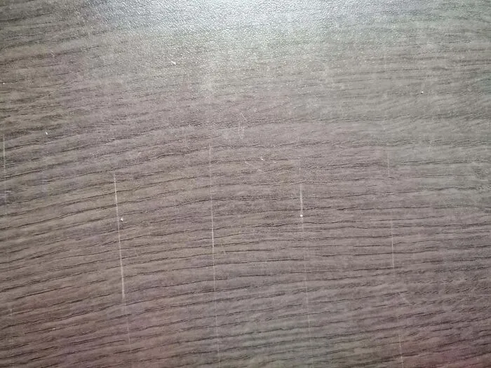My Brother's Girlfriend Moved In With Us, And She Refuses To Use Cutting Boards. This Is What Our Kitchen Table Looks Like Now. They're All Over It