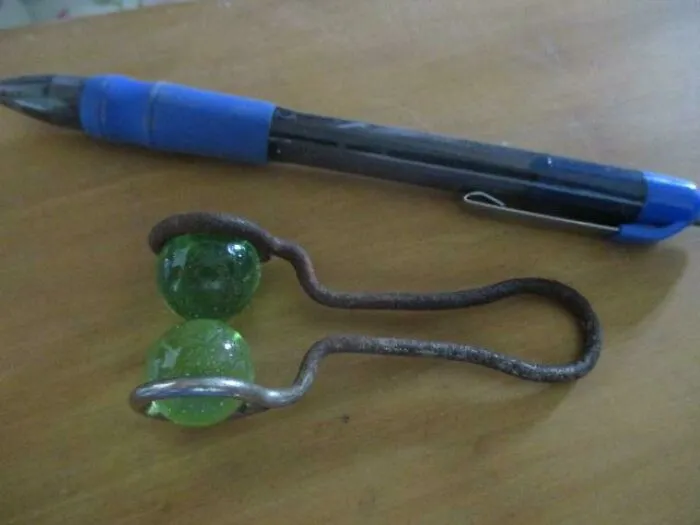 This Is A Steel Wire Frame With Two Glass Marbles. It Was Found In An Old Garage Among Various Stuff. The Marbles Can Turn Inside The Frame