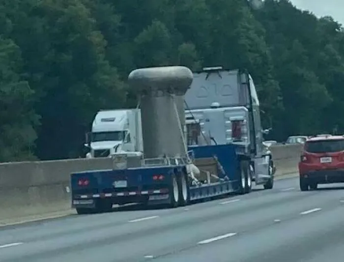 Signs On The Truck Say ‘Radioactive’. Metallic Dumbbell-Shaped Container