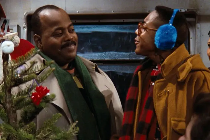 Steve and Carl next to a Christmas tree 