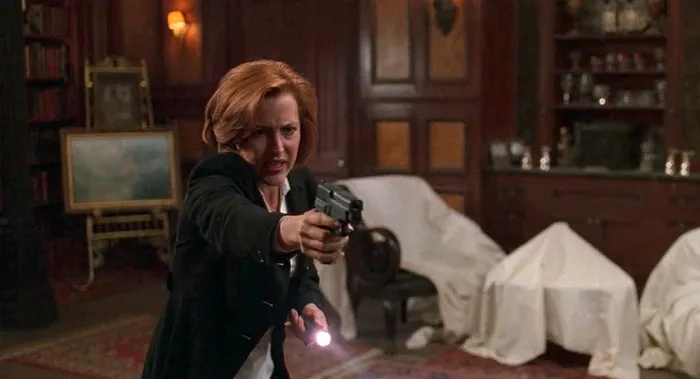 Dana holding a gun 