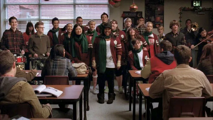 Acapella group singing in front of a class 