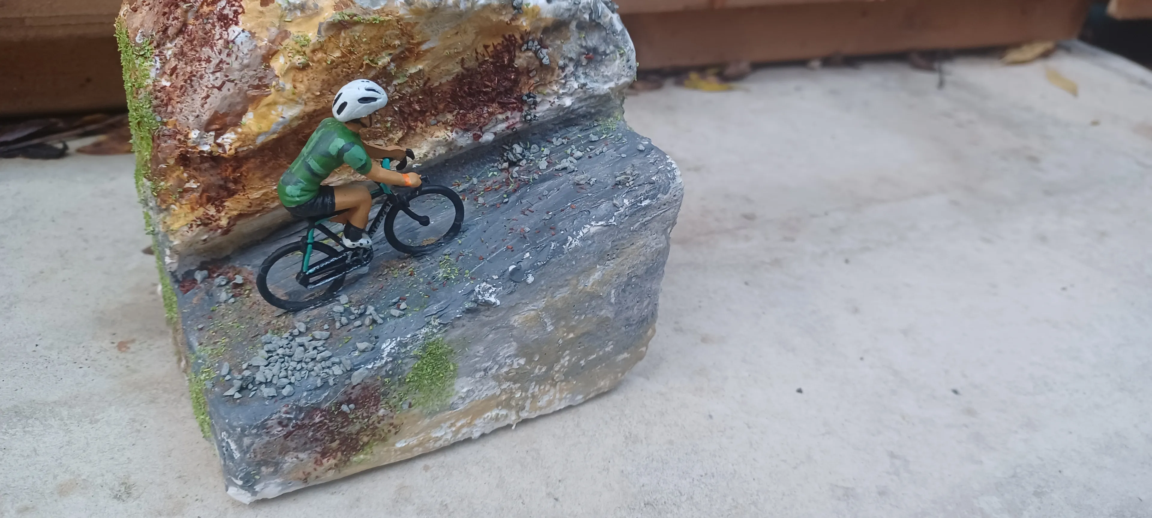 Miniature Cyclist On Mountain