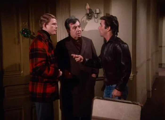Three men talking on the hallway 