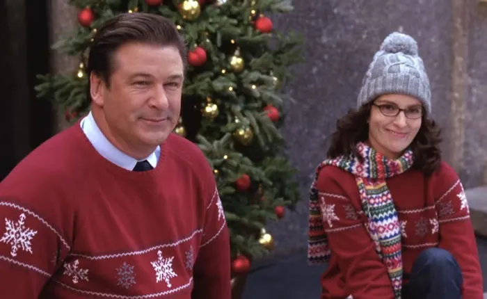 Liz and Jack wearing Christmas sweaters 