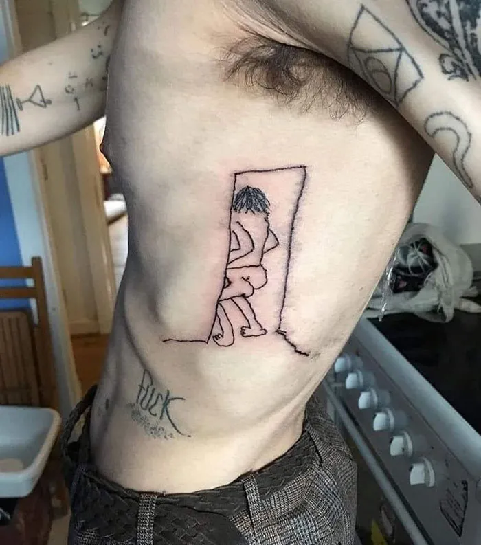Bad tattoo of a stick figure on a person's side, showcasing poor design and execution.