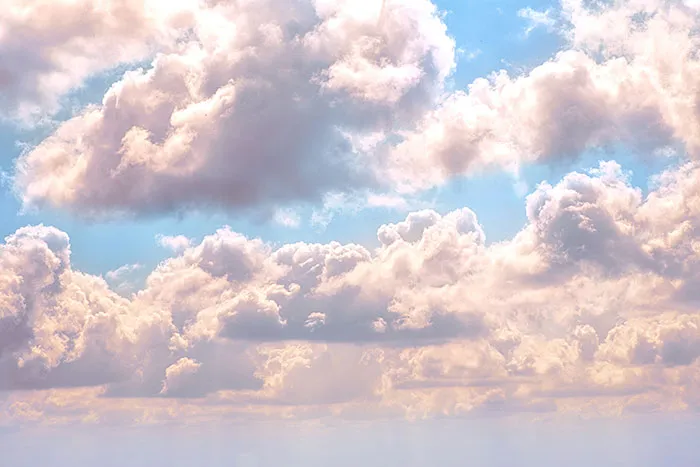 Fluffy clouds in a blue sky, perfect for serene me time reflection.