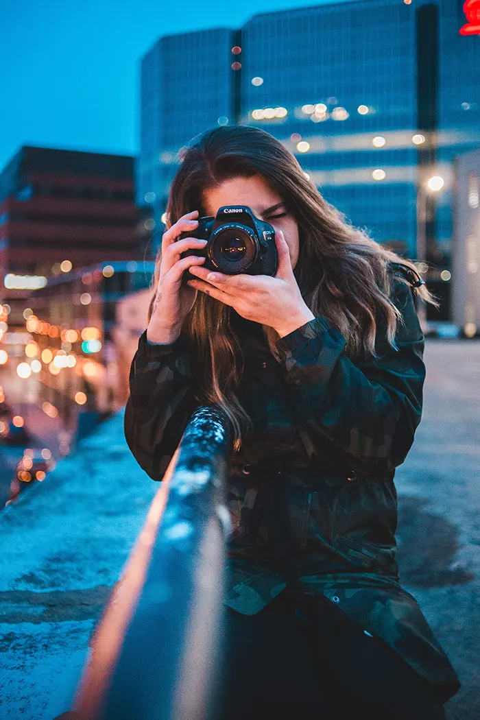Person in a city taking photos, enjoying some me time with a camera.