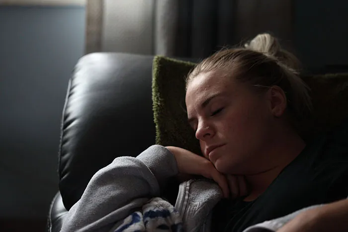 Person enjoying a nap on a couch for relaxing "me time."