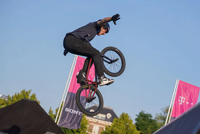 Person performing solo tricks on bike outdoors, showcasing exciting ways to enjoy "me time."