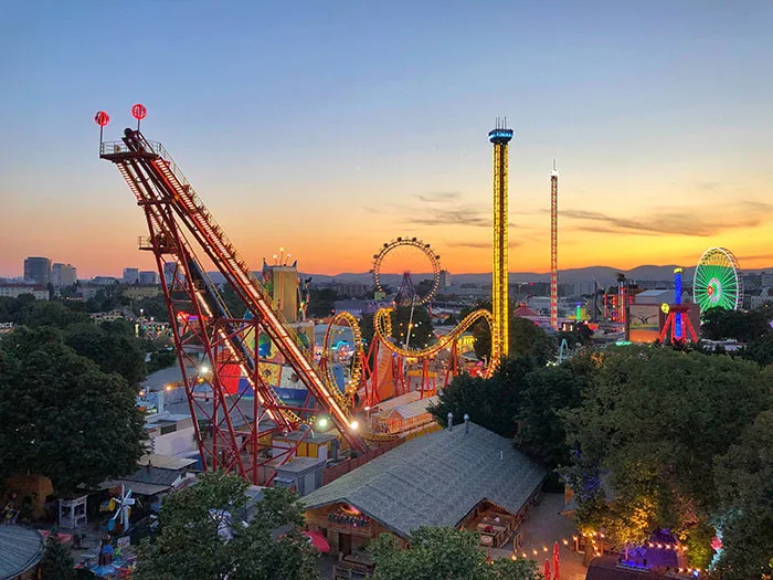 Amusement park at sunset, with vibrant rides and attractions, perfect for enjoying some me time.