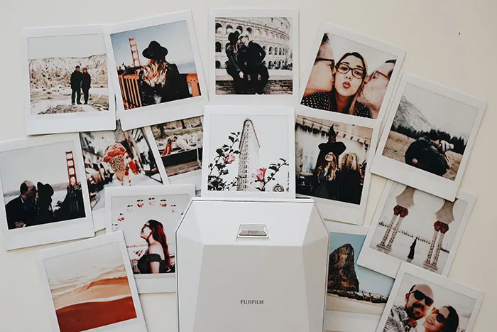 Old photos scattered on a surface, capturing memories and solo adventures for some "me time."