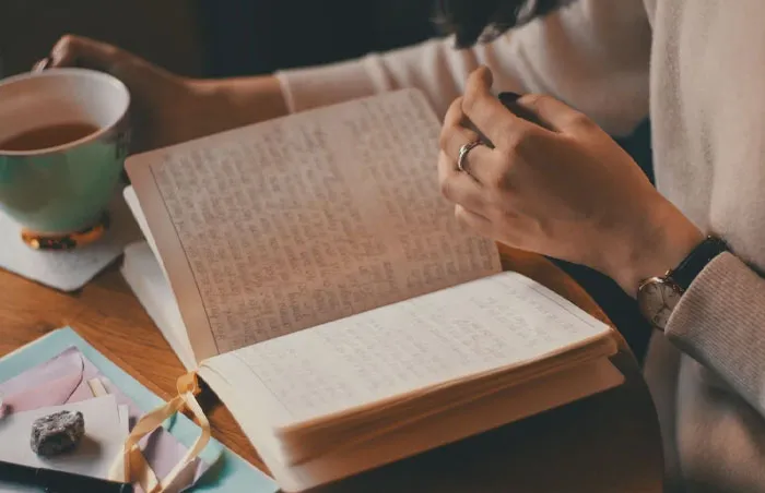 Woman drinking coffee and reading notes 