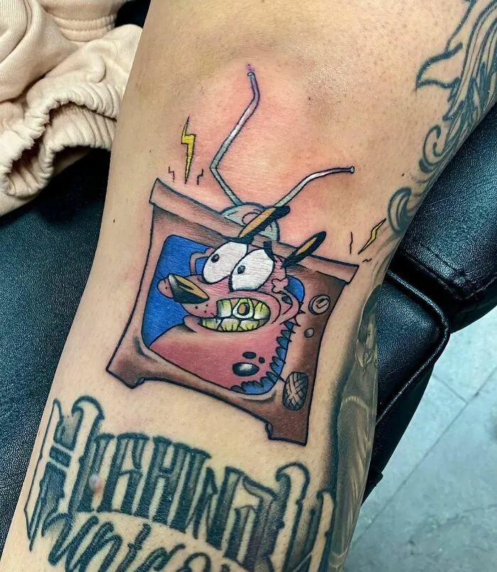 Cartoon tattoo featuring animated TV character on arm, inspired by popular animated shows.
