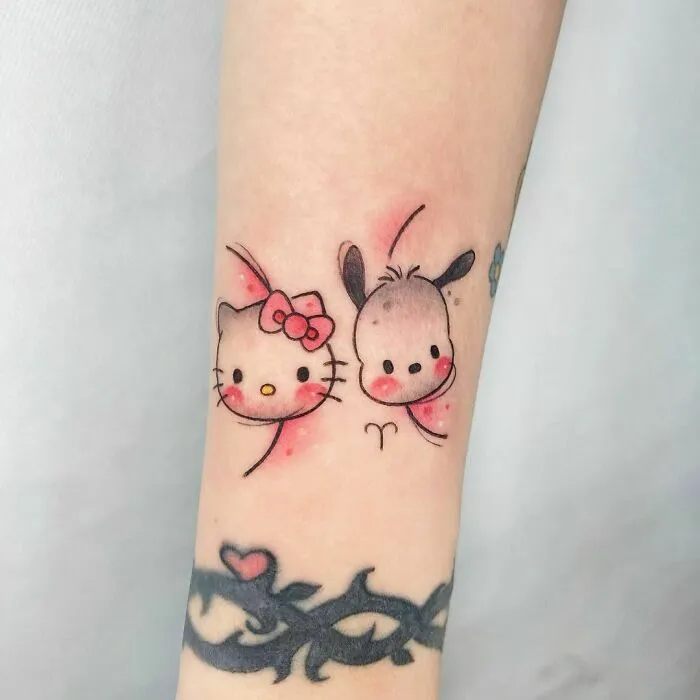 Cartoon tattoo featuring cute characters from beloved animated shows on forearm.