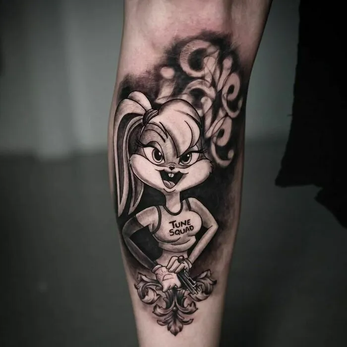 Cartoon tattoo of an animated character in a "Tune Squad" jersey on an arm, inspired by favorite animated shows.