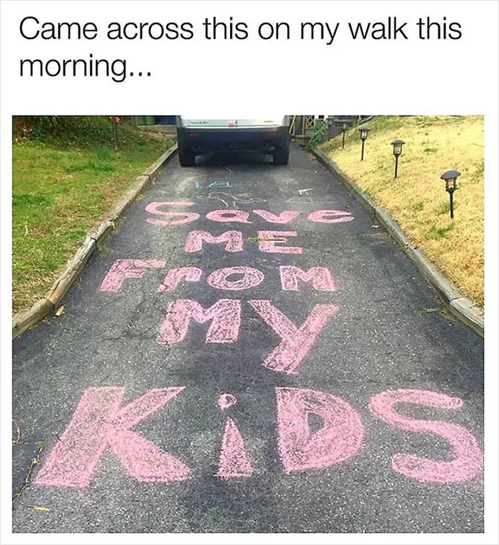 Driveway message reading "Save me from my kids" written in pink chalk, humorously depicting average parent problems.