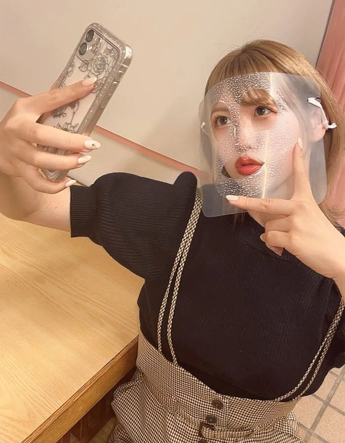 Person wearing a clear face mask takes a selfie, showcasing a clever take on a mundane Halloween costume.