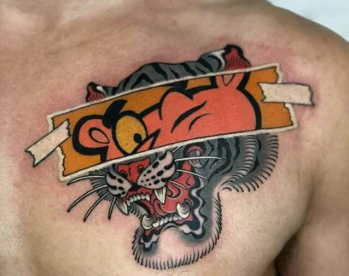 Trippy tattoo of a tiger and cartoon character merging on chest.