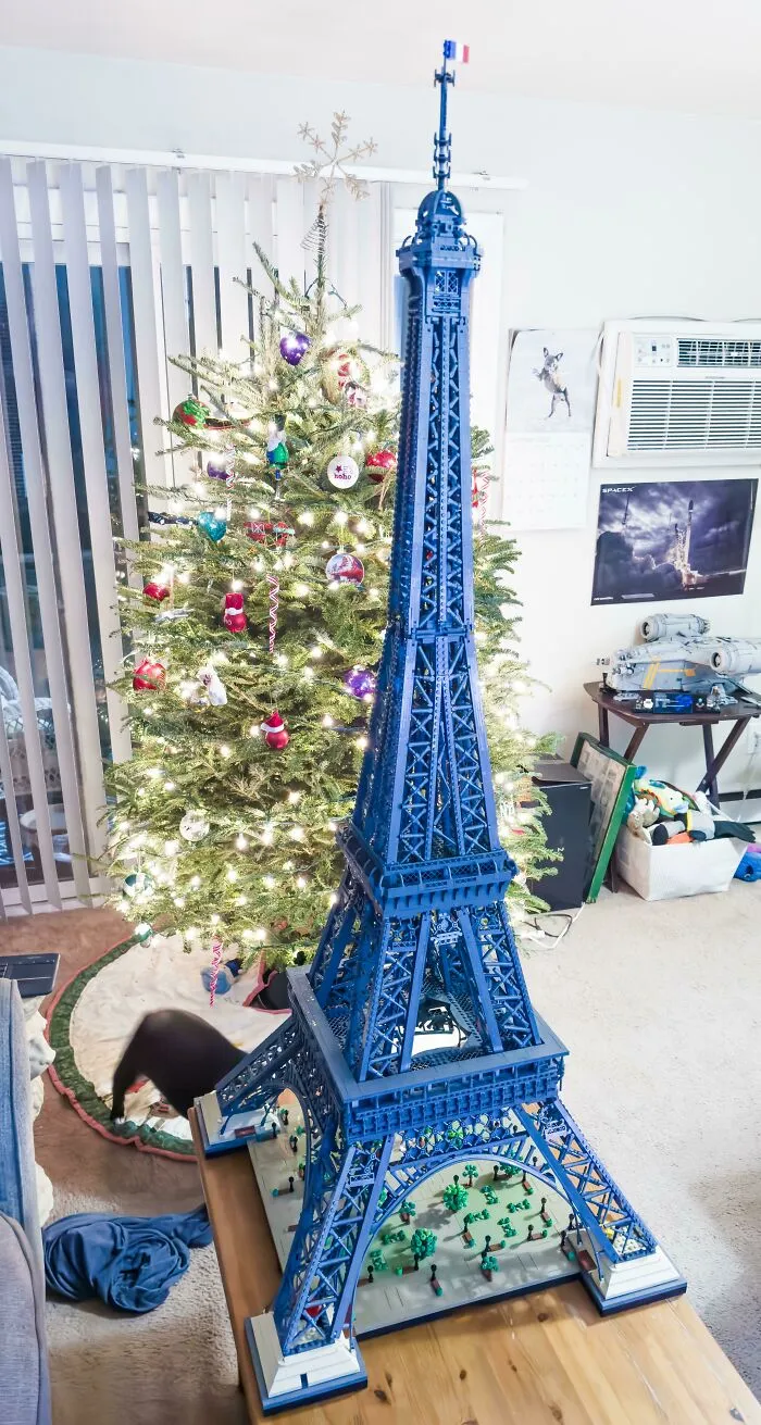 Detailed LEGO Eiffel Tower build displayed indoors near a decorated Christmas tree, showcasing incredible LEGO builds.