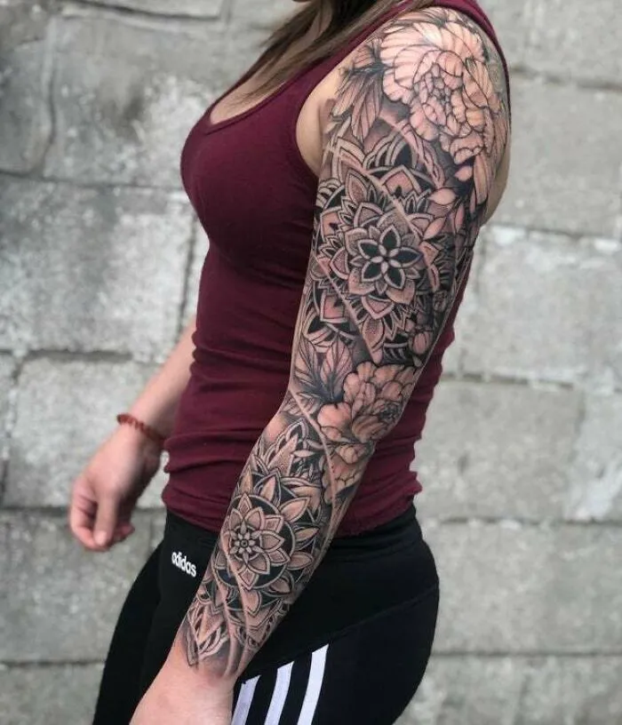 Arm with intricate trippy tattoo design, showcasing floral patterns, ideal for lovers of psychedelic art.