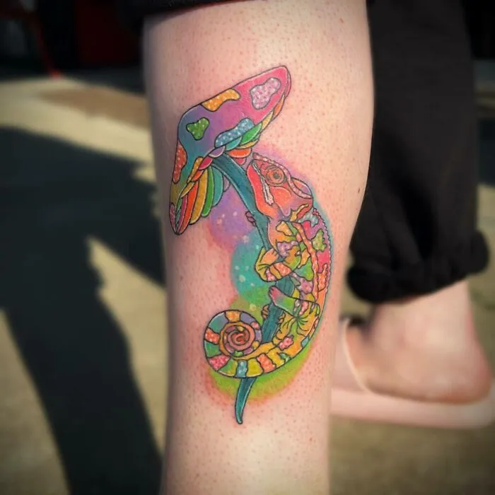 Colorful tattoo of a chameleon and mushroom on a leg, exemplifying trippy tattoo ideas.