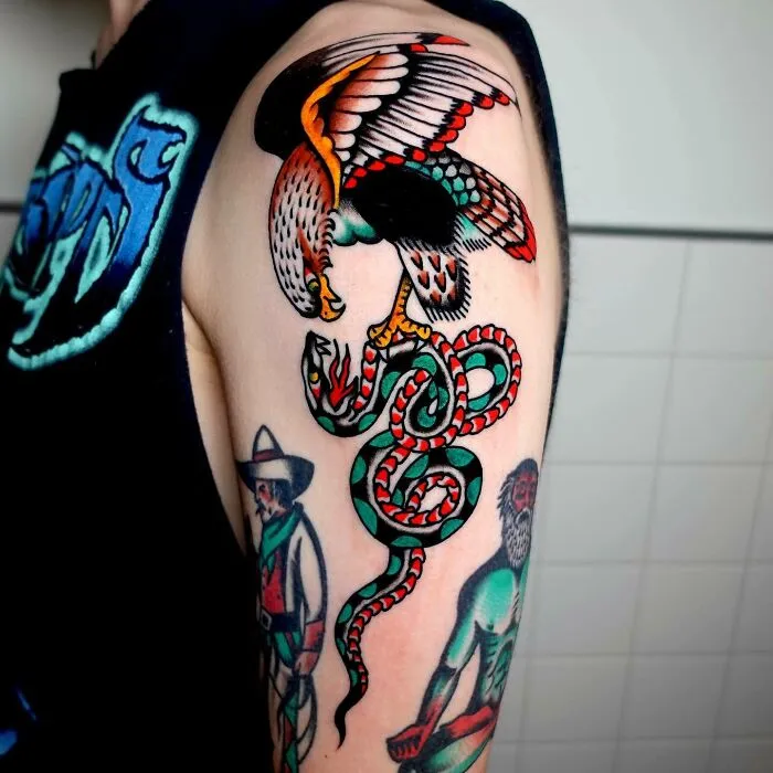 Colorful psychedelic tattoo of an eagle and snake on an arm, showcasing vibrant trippy art design.
