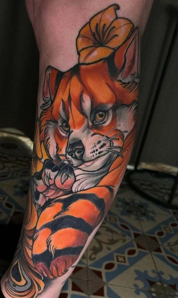 Psychedelic art tattoo of a colorful fox on an arm.