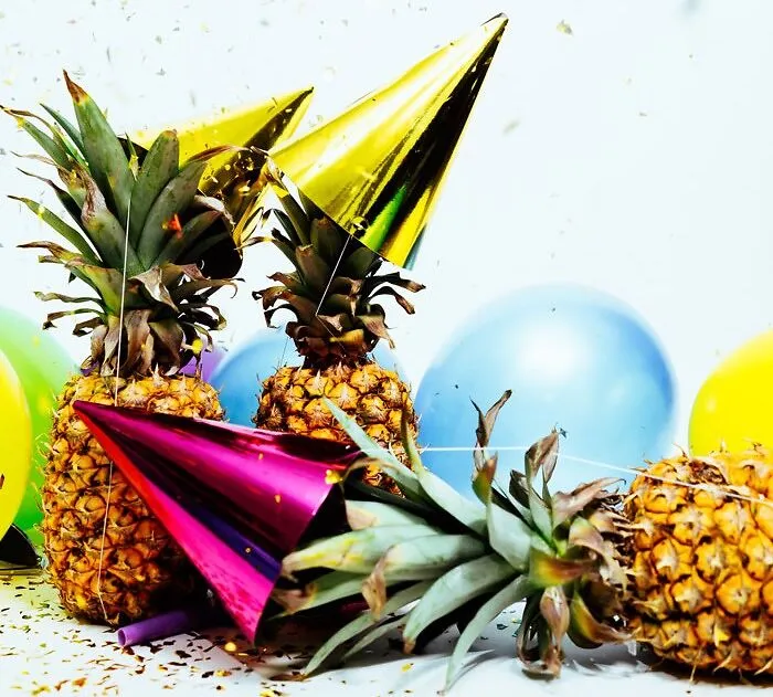 pineapples with party caps on them