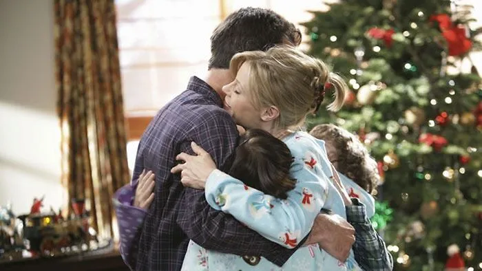 The Dunphy family hugging 