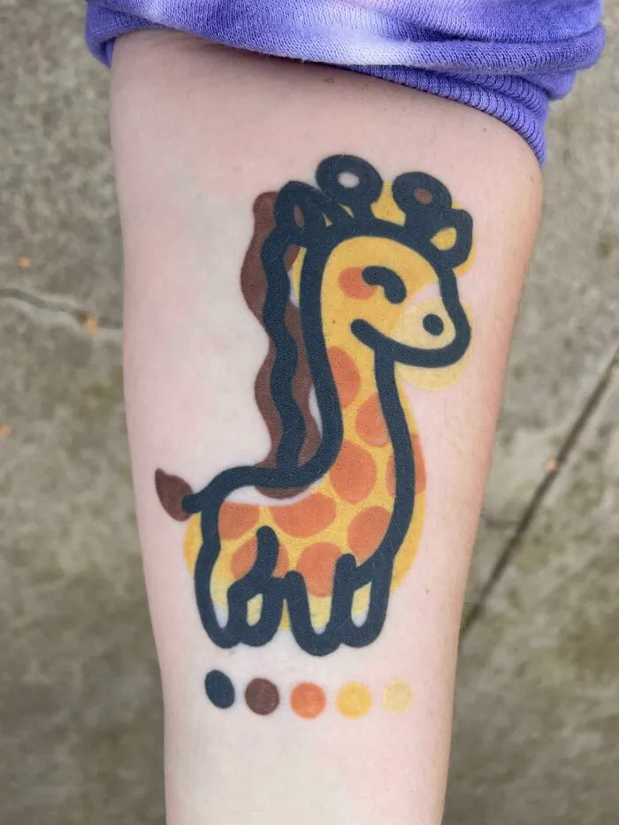 Psychedelic art tattoo of a colorful giraffe design on an arm.
