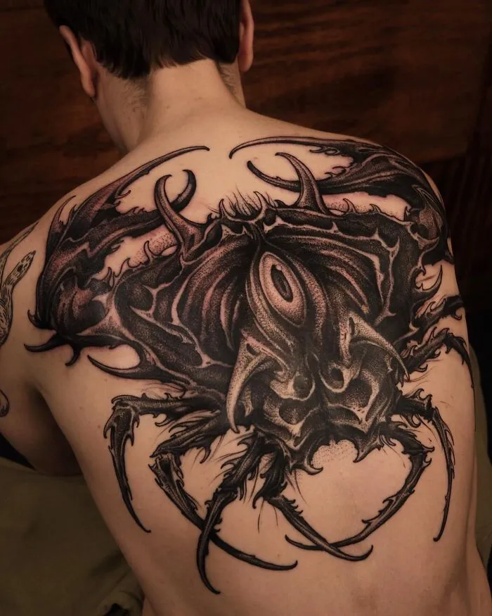 Back tattoo showcasing intricate trippy art with a psychedelic theme, featuring abstract design elements.