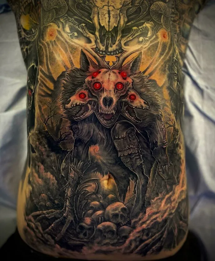 A trippy tattoo featuring a multi-eyed wolf with psychedelic details and skull motifs, illustrating vivid psychedelic art.