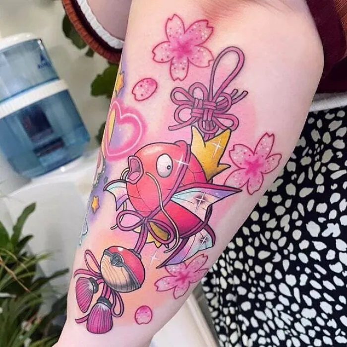Colorful trippy tattoo of a fish and pink flowers, showcasing psychedelic art on an arm.