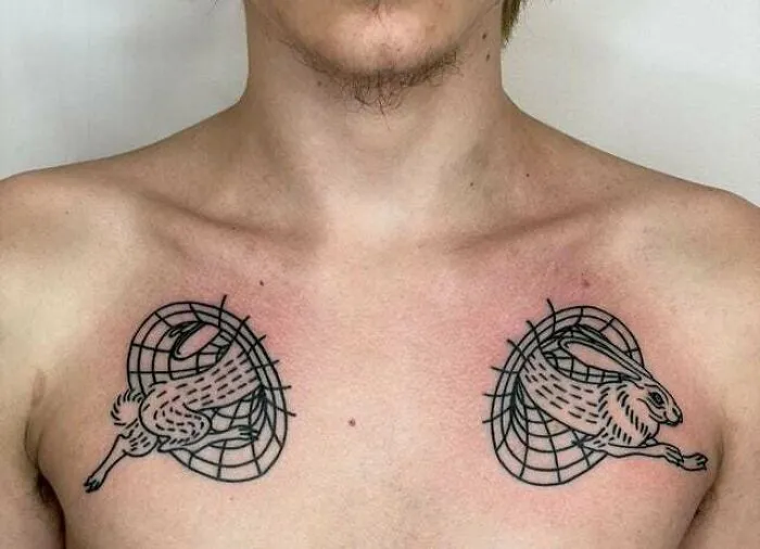 Chest showcasing trippy tattoos of rabbits emerging from geometric patterns.