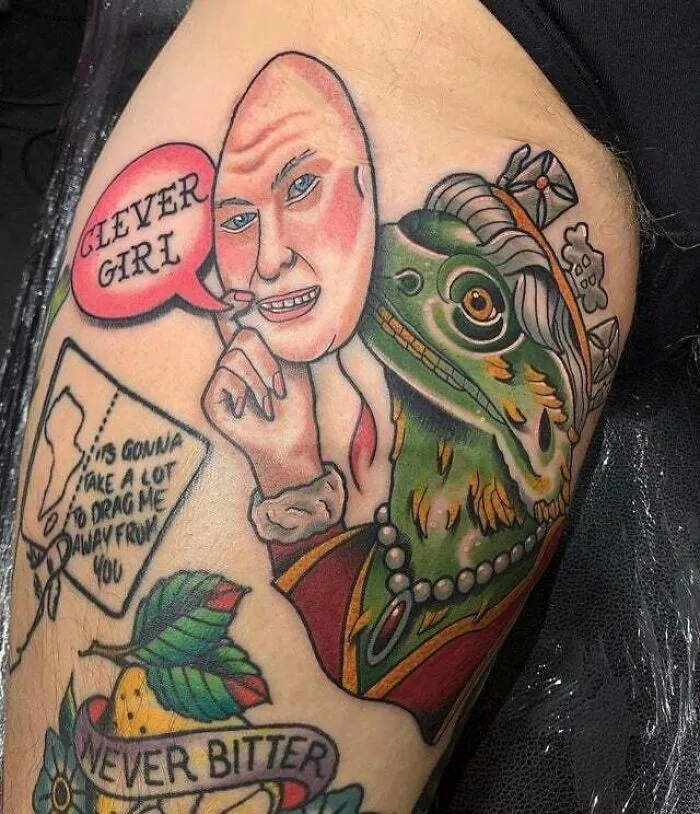 Trippy tattoo of Queen E-Lizard-Beth depicting a human face with a lizard's body and whimsical text on a leg.