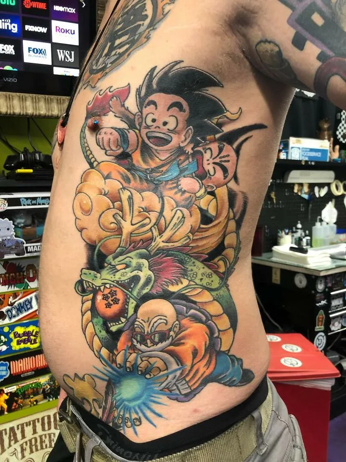 Cartoon tattoo of animated characters on a person's side, inspired by a popular animated show.
