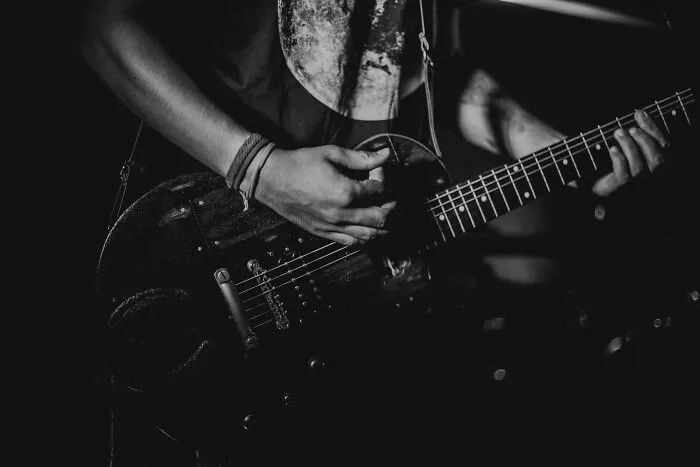 Musician playing electric guitar at a New Year’s Eve concert.