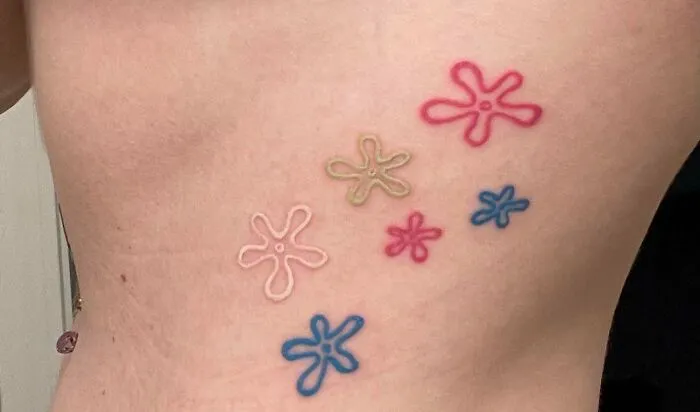 Cartoon tattoo with colorful star designs inspired by beloved animated shows.