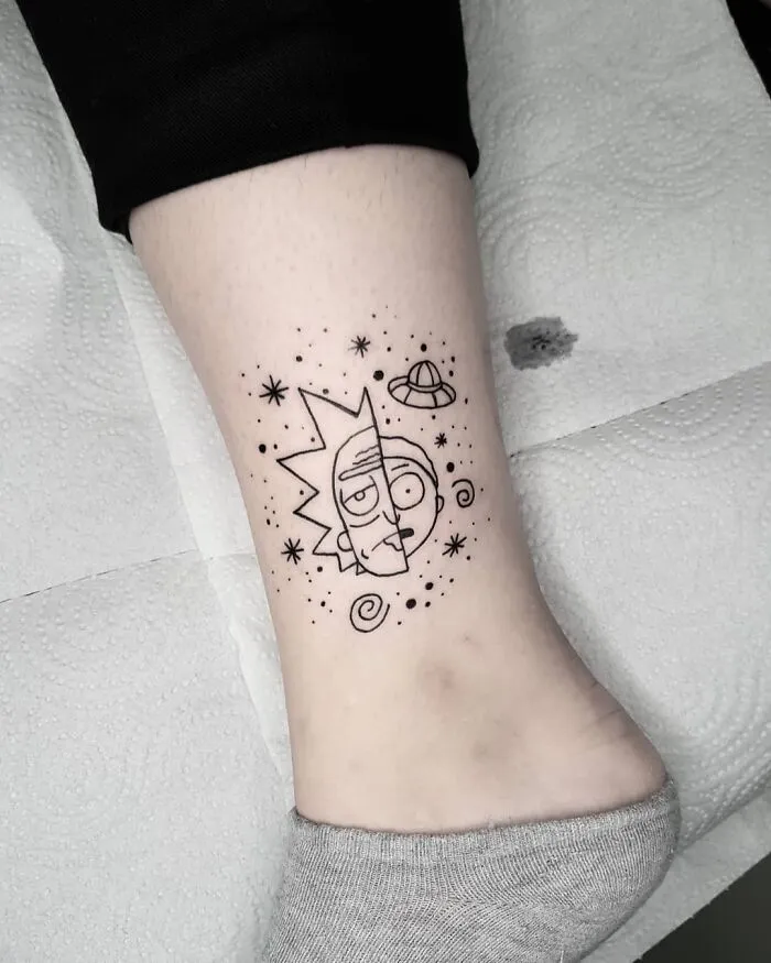 Cartoon tattoo of Rick and Morty characters in space theme on a person's ankle.