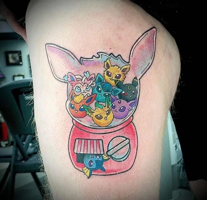 Colorful cartoon tattoo of animated character heads in a red gumball machine.