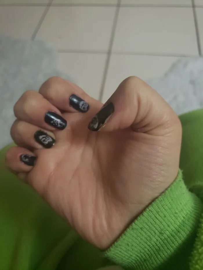 A hand showing dark gothic-style nails, a unique choice for winter nail art designs.
